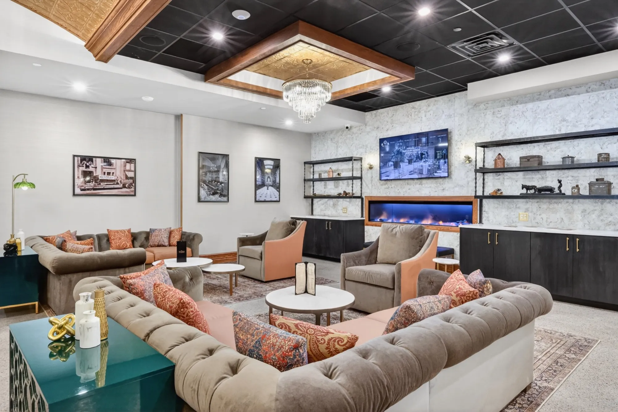 The café lounge with sofas, a fireplace, and framed artwork