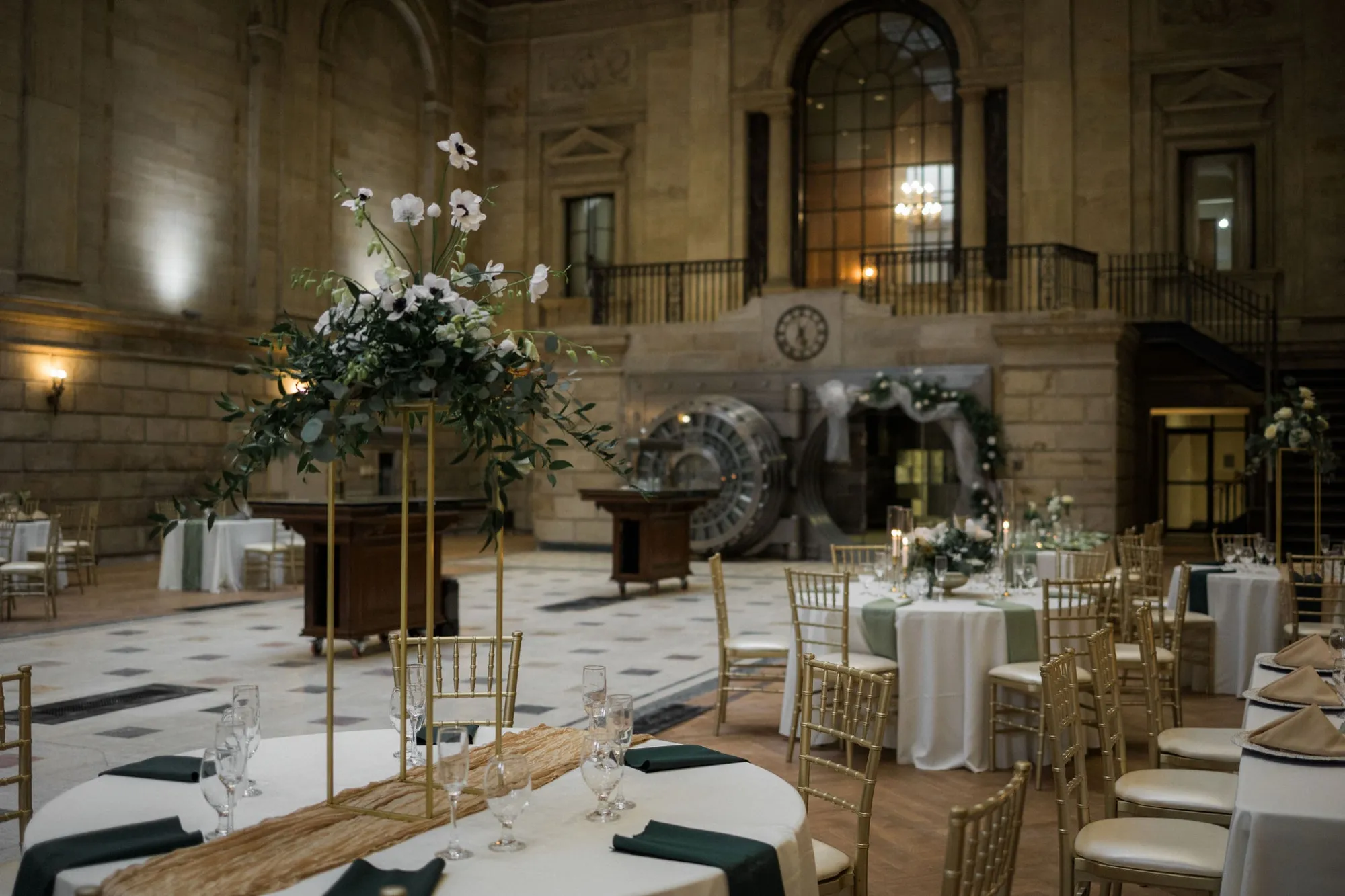 A wedding reception set beneath the vaulted ceiling of the Vault Room