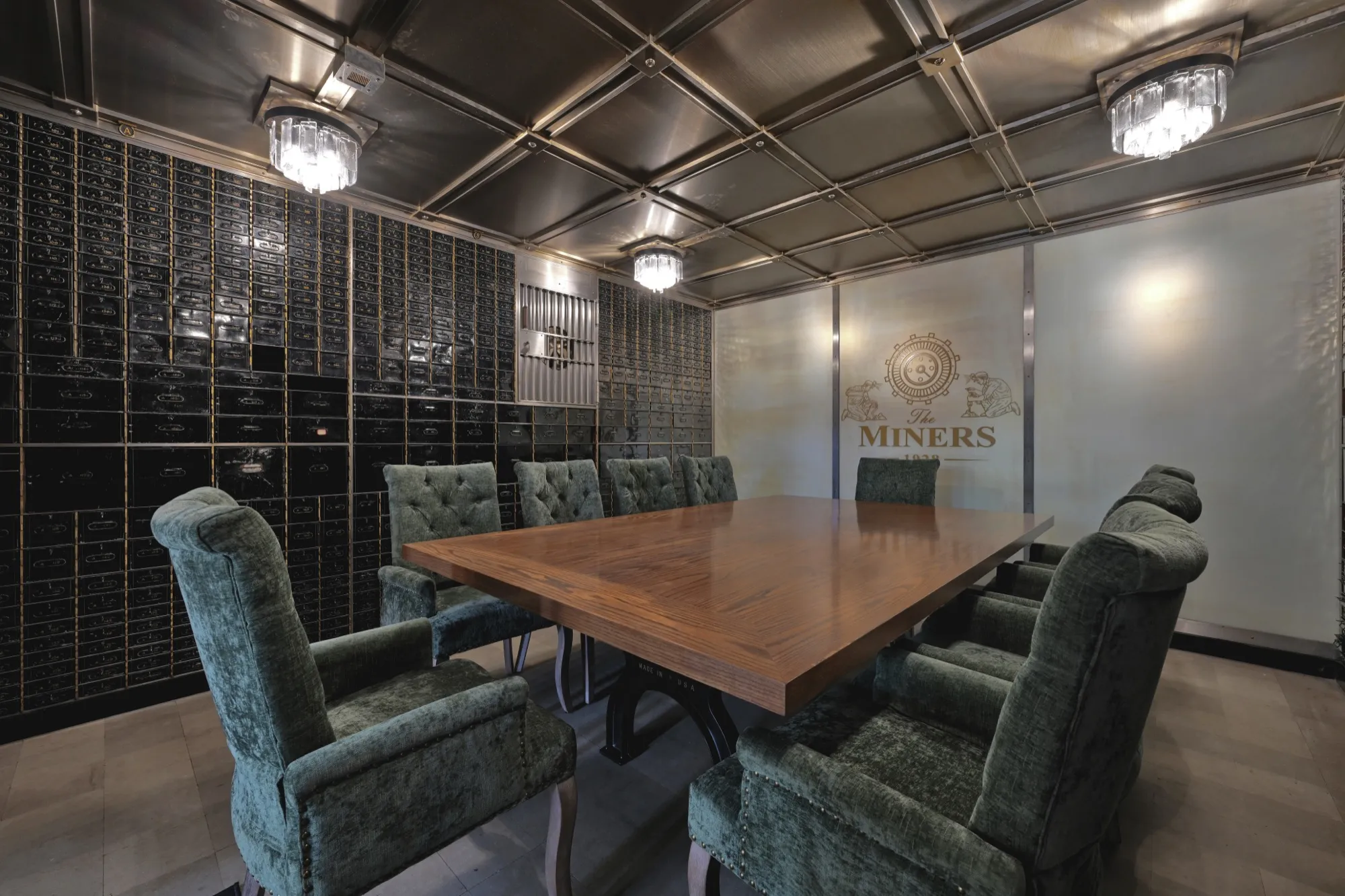 An intimate meeting in the historic vault, lined with original safe-deposit boxes