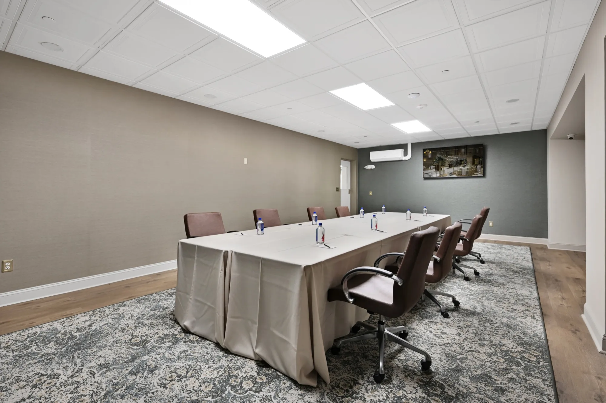 A boardroom-style conference setup with a long meeting table