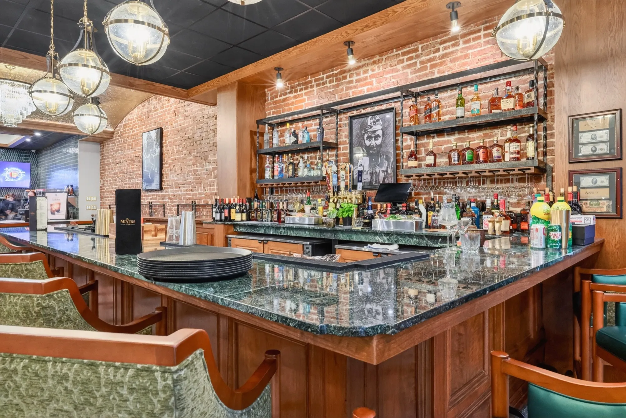 The custom green-marble bar top at Lounge 28, carved from the original bank counters