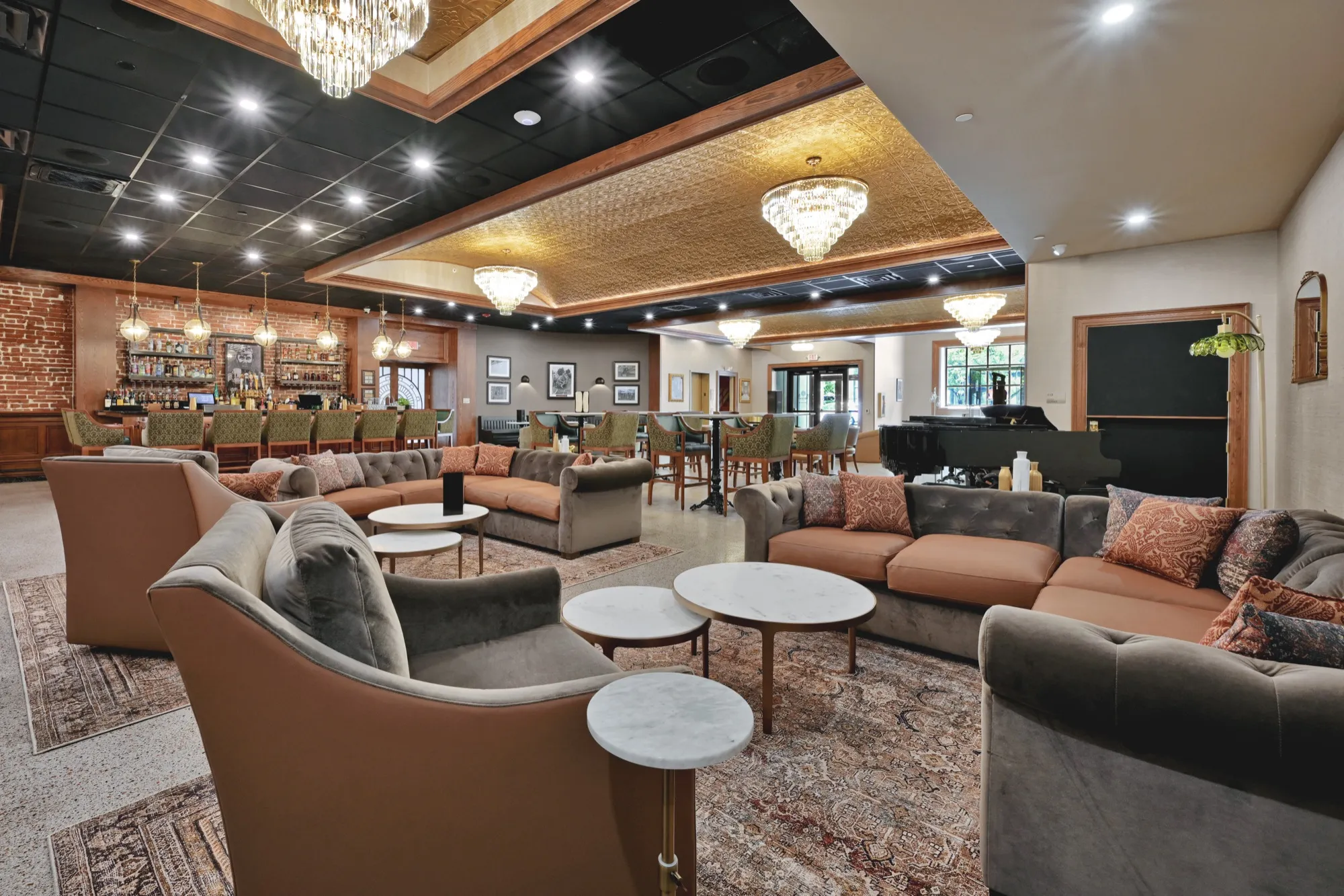 The lounge at Lounge 28, with velvet seating, chandeliers, and the bar beyond