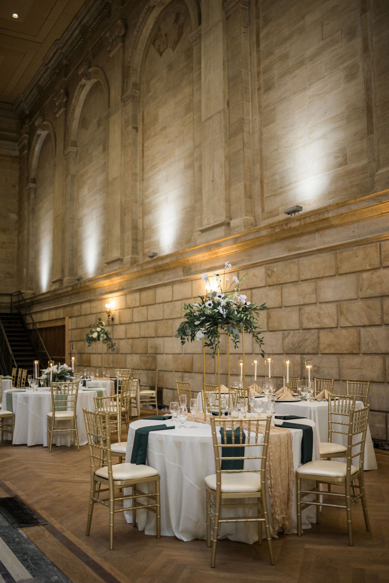The grand interior of The Miners 1928 banking hall with vaulted ceilings, chandeliers, and limestone walls