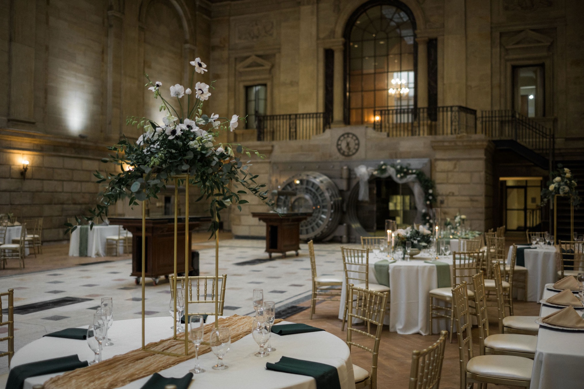 The Bank Lobby at The Miners 1928, featuring soaring vaulted ceilings, marble floors, and tables set for a wedding reception