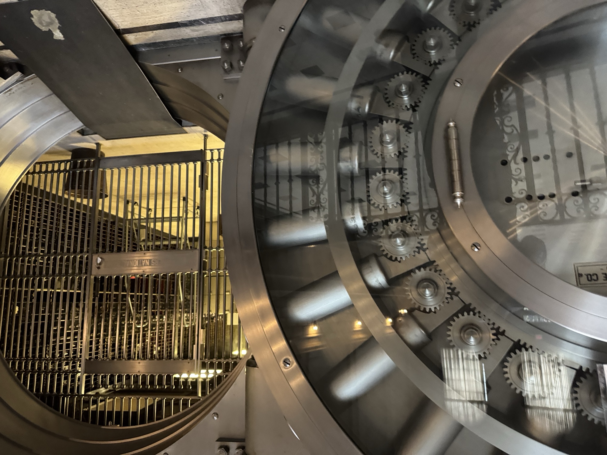 The 36-ton vault door showing massive steel gears, locking bolts, and brass cage interior